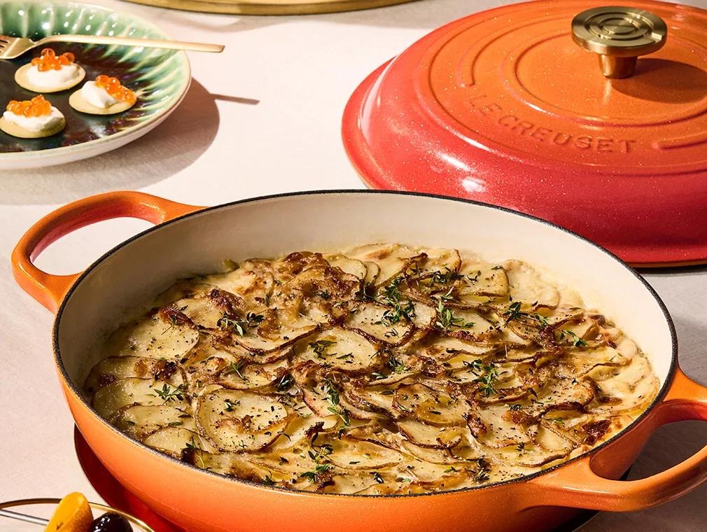Truffle potato gratin with a golden Gruyère topping in a Le Creuset casserole dish