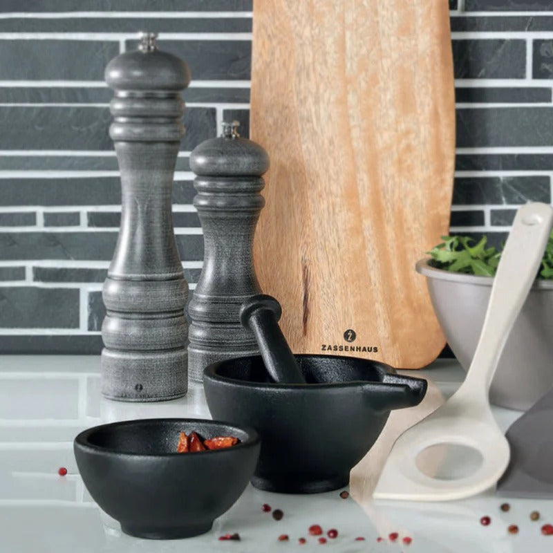Zassenhaus cast iron mortar and pestle with peppercorns, pepper mills and chopping board