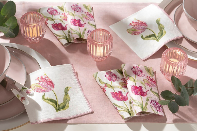 IHR paper napkins with pink tulip print on a table with candles and blush pink dinnerware