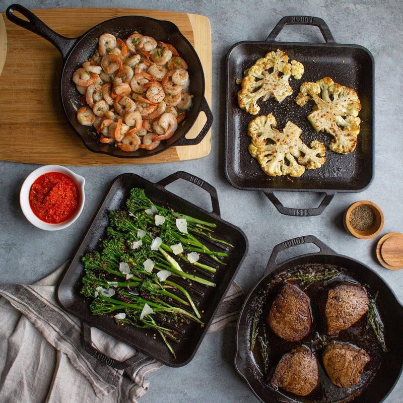 Lodge cast iron skillets and grill pans with garlic shrimp, roasted cauliflower, charred broccolini and seared steaks