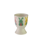 Avanti egg cup in cream with a pattern of coloured Easter bunnies holding eggs