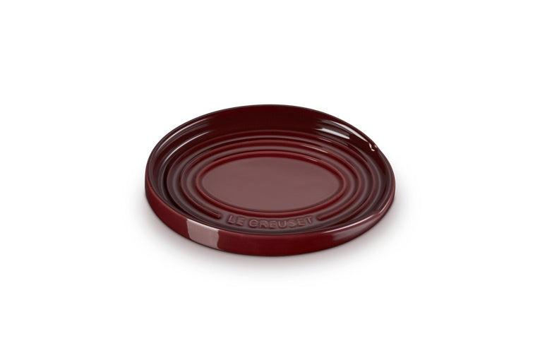 Le Creuset stoneware oval spoon rest in deep red with ridged rings