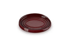Le Creuset stoneware oval spoon rest in deep red with ridged rings