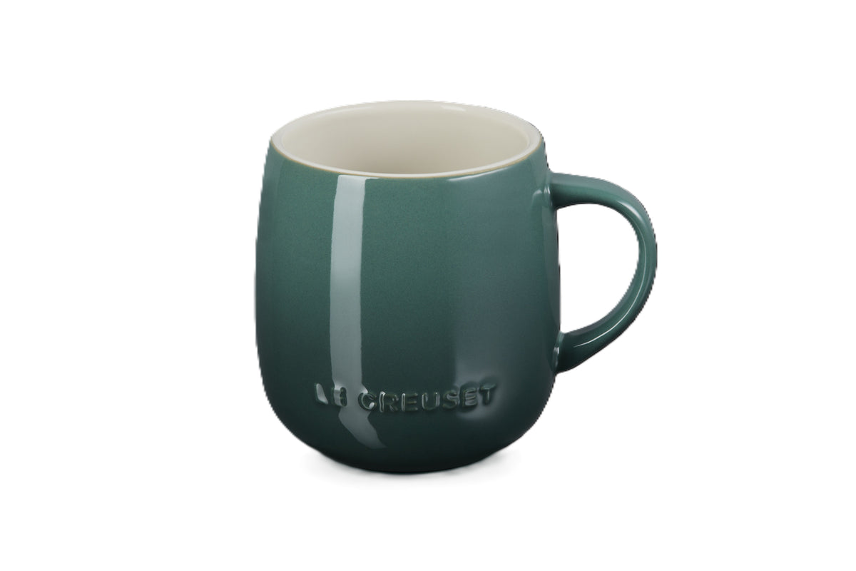Le Creuset stoneware U mug in deep green with a rounded body and a curved handle