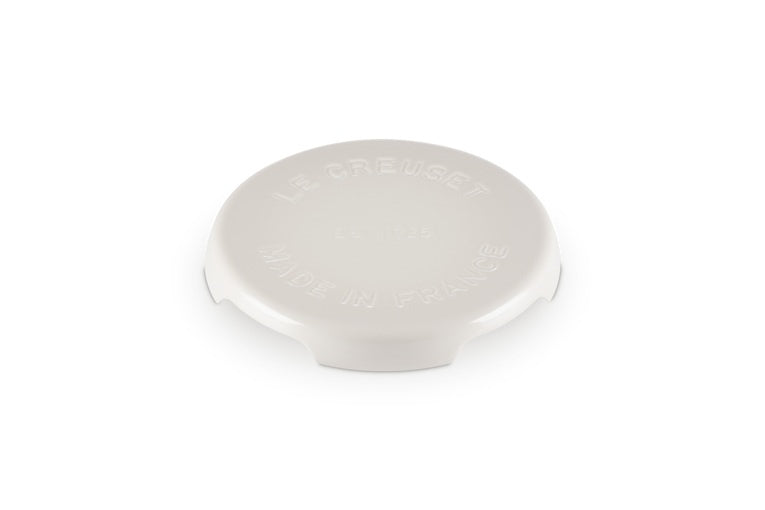 Le Creuset cast iron Signature round trivet in cream with the Le Creuset name on the top