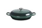 Le Creuset Signature shallow casserole in dark green enamelled cast iron with a lid and two side handles