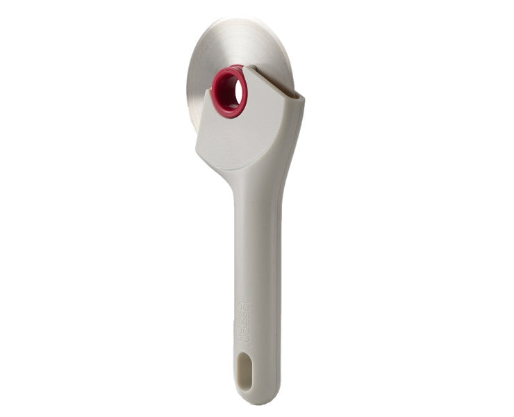 Joseph Joseph Ringo pizza wheel with a cream handle and a raspberry coloured centre hub