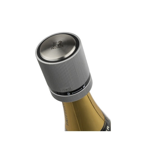 Peugeot Line bottle stopper in ribbed stainless steel, shown on a wine bottle