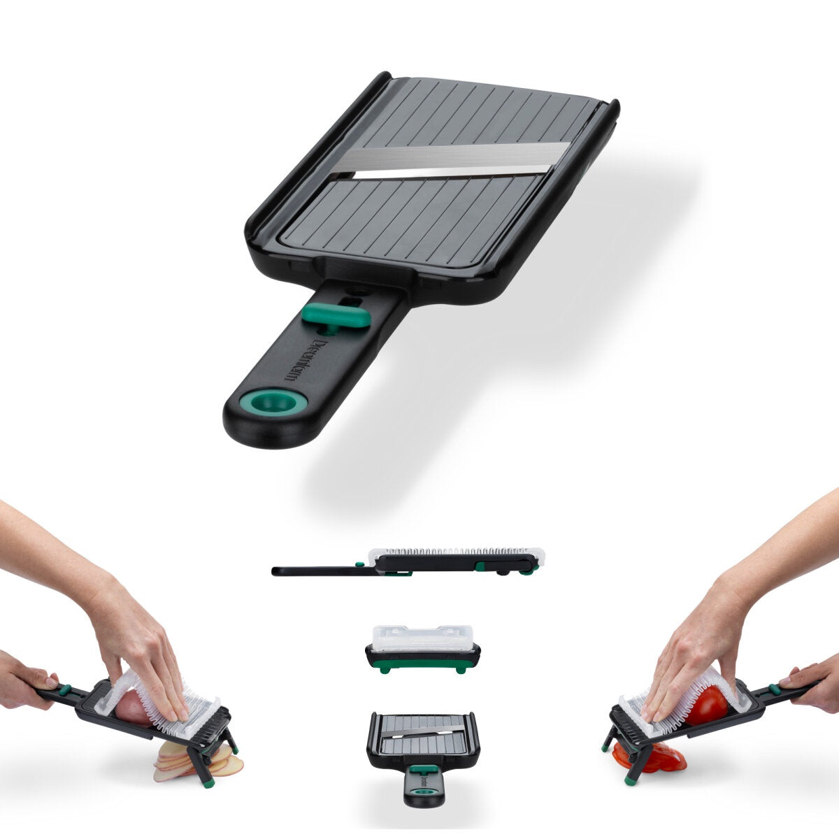 Dreamfarm Nocutu mandoline in black and green with a folding stand, shown slicing bread and tomato