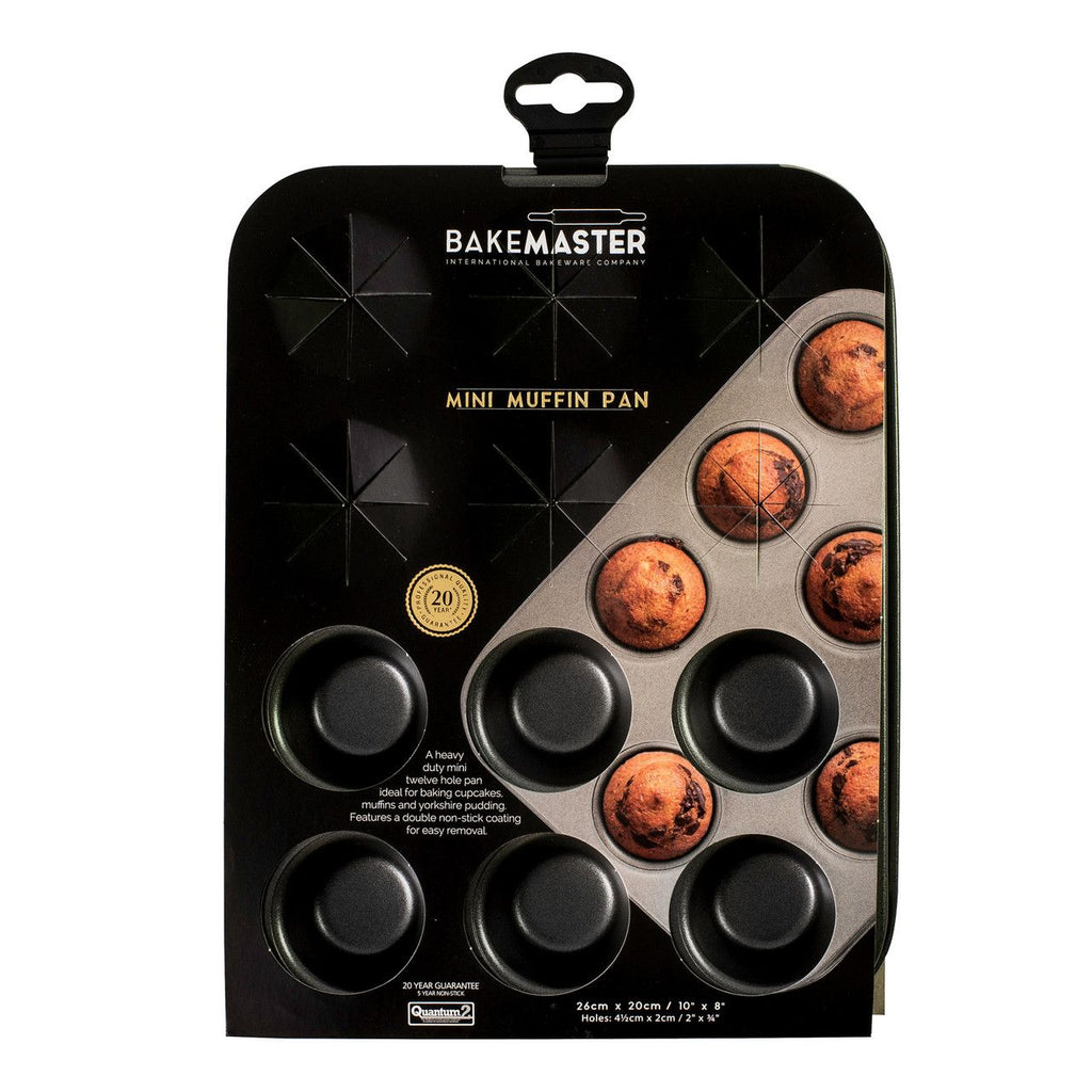 Bakemaster mini muffin pan in dark non-stick steel, shown in its packaging with mini muffins