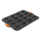 Bakemaster silicone 16 cup madeleine pan in black with orange corner tabs