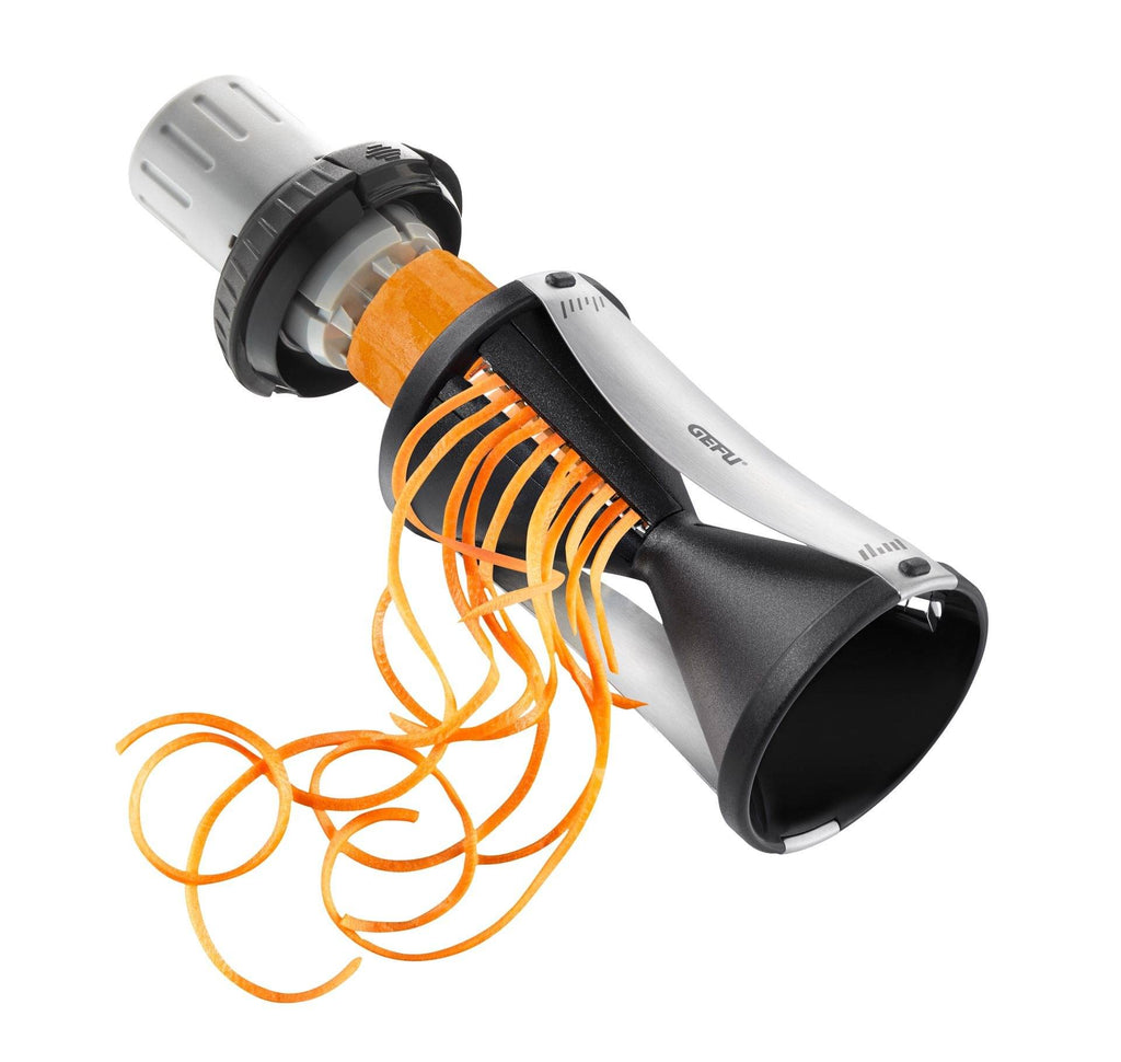 Gefu Spirelli 2.0 spiral slicer in black and steel, producing orange vegetable spirals