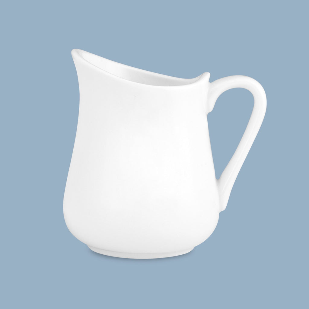 Wilkie Brothers milk jug in white porcelain on a blue backdrop