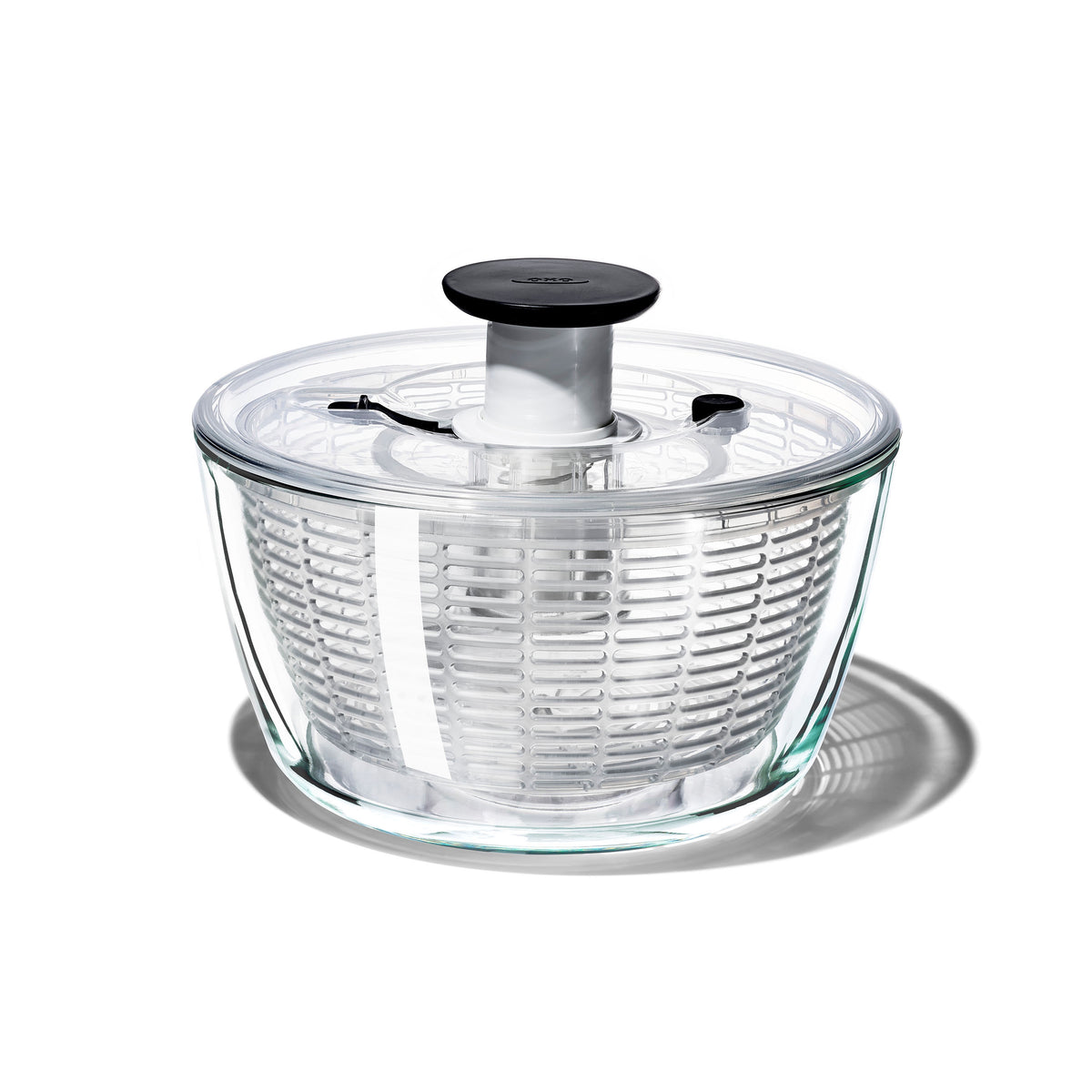 OXO Good Grips glass salad spinner with a clear bowl, a black lid and a pump button