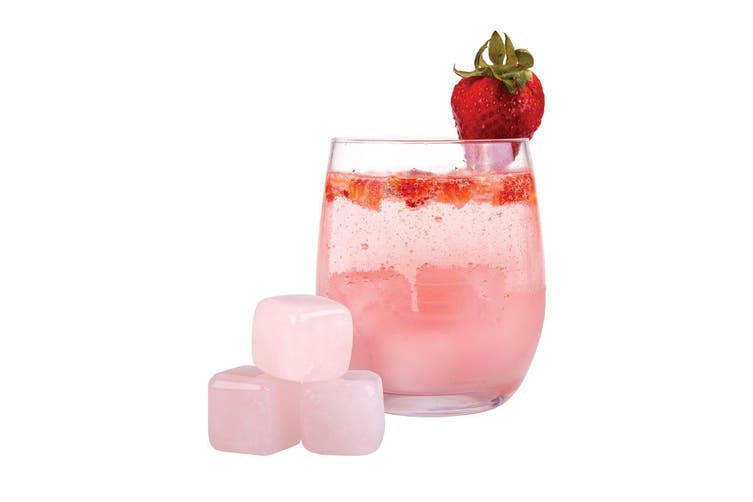 Bartender Quartz Gin Stones, pink rose quartz cubes beside a pink strawberry drink in a glass