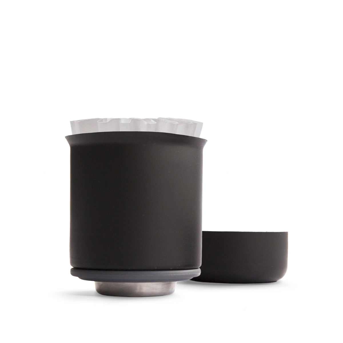 Stagg XF pour-over coffee dripper in matt black with a paper filter and a matching base