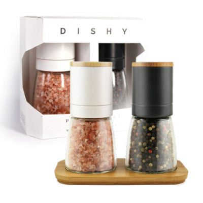 Dishy Futago salt and pepper mill set, two glass mills with wooden lids filled with pink salt and peppercorns on a bamboo tray