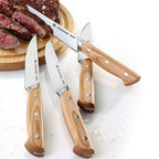 Zassenhaus wooden steak knife set of four with light wood handles, shown with sliced steak