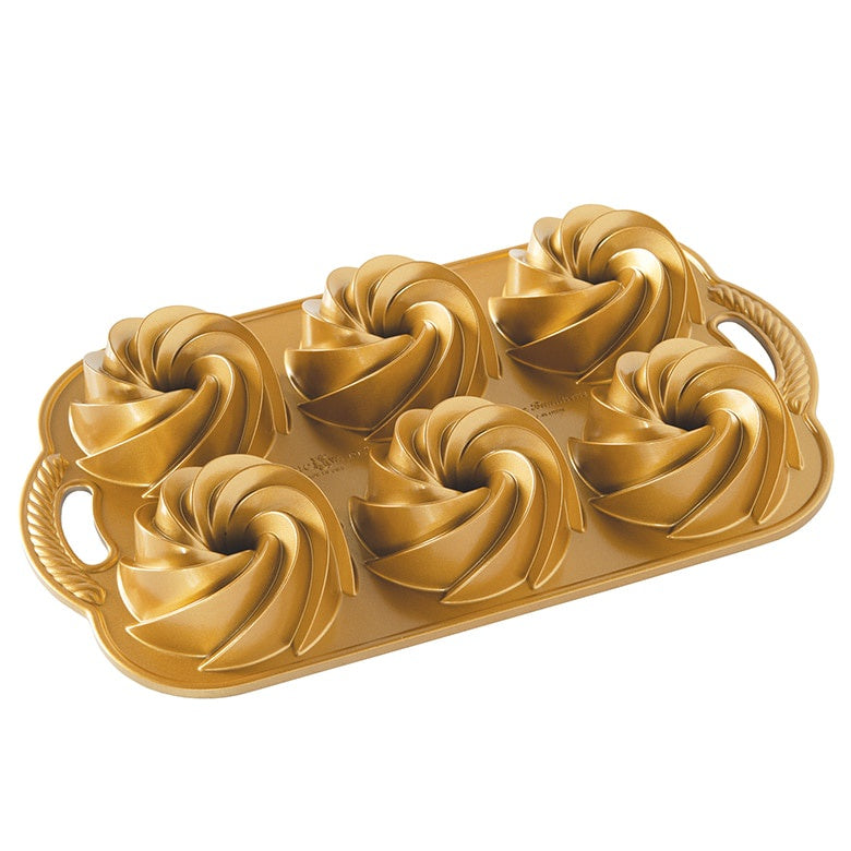 Nordic Ware Heritage Bundtlette pan in gold with six fluted swirl cavities