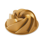 Nordic Ware Heritage bundt pan in gold with a swirled fluted design