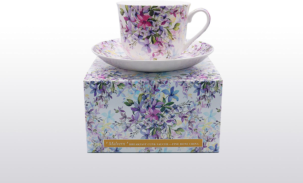 Heritage breakfast cup and saucer with a Malvern pattern of blue and purple flowers, shown on its gift box