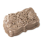 Nordic Ware Wildflower loaf pan in gold, a cast pan with an embossed flower bouquet design