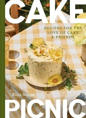 Cake cookbook cover with a photo of a frosted layer cake on a gingham tablecloth