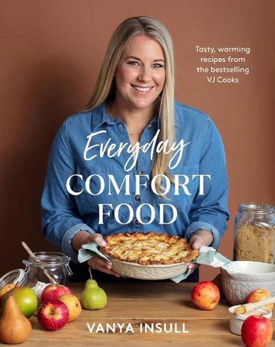Everyday Comfort Food cookbook by Vanya Insull, with the author holding a pie among apples and pears