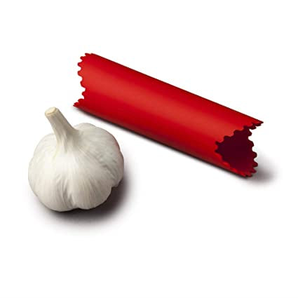 Zeal garlic peeler, a red silicone tube, shown beside a garlic bulb