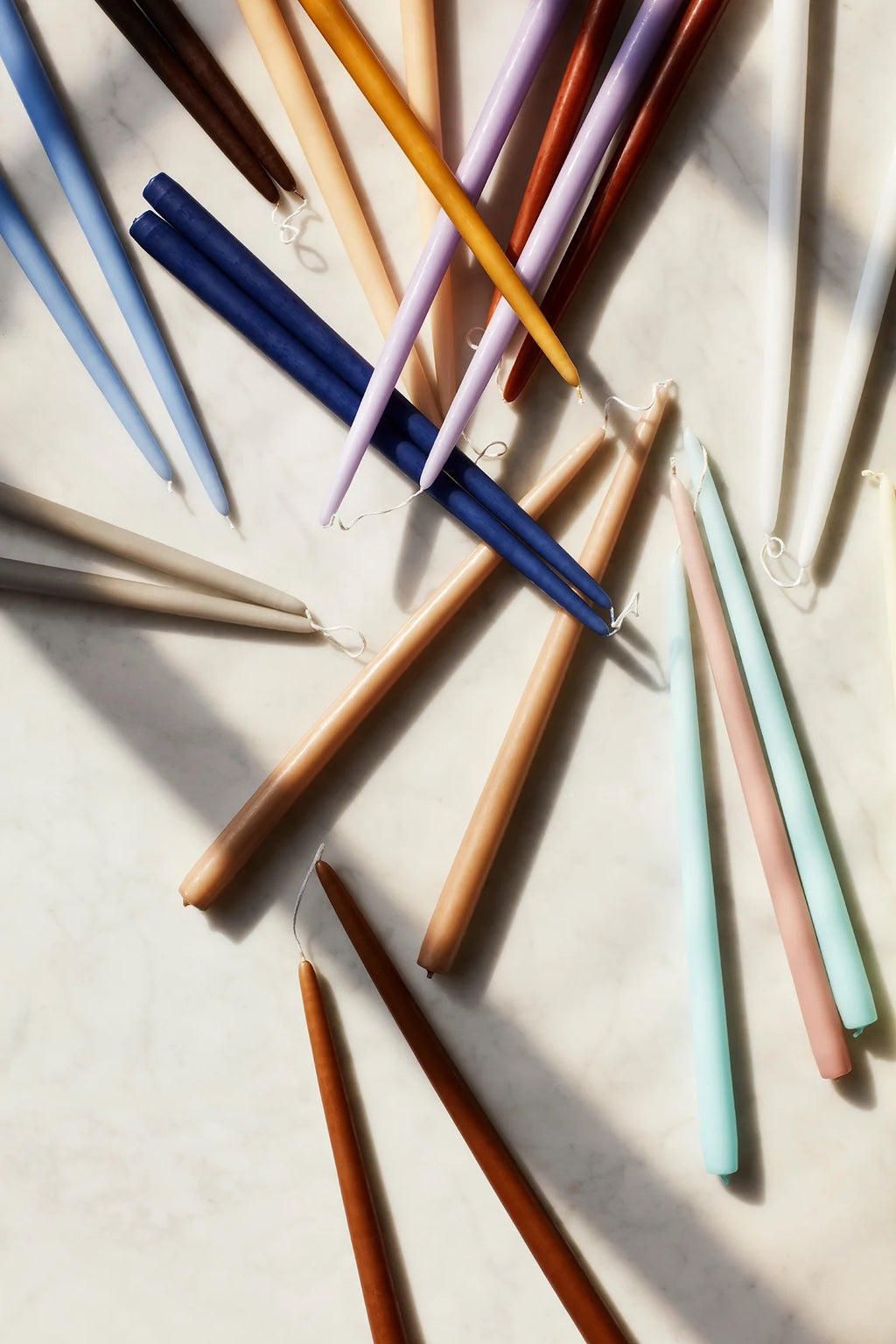 Broste candle tapers in assorted colours including navy, mustard and dusty pink