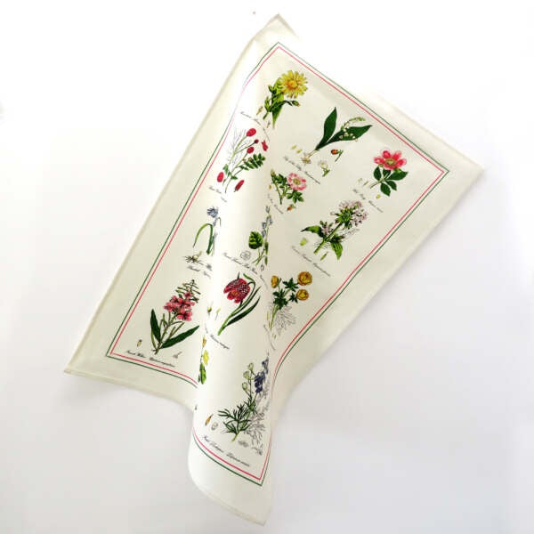 Samuel Lamont Botanical Garden tea towel printed with labelled wild flowers and a red border