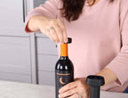 Corkie being applied to a wine bottle