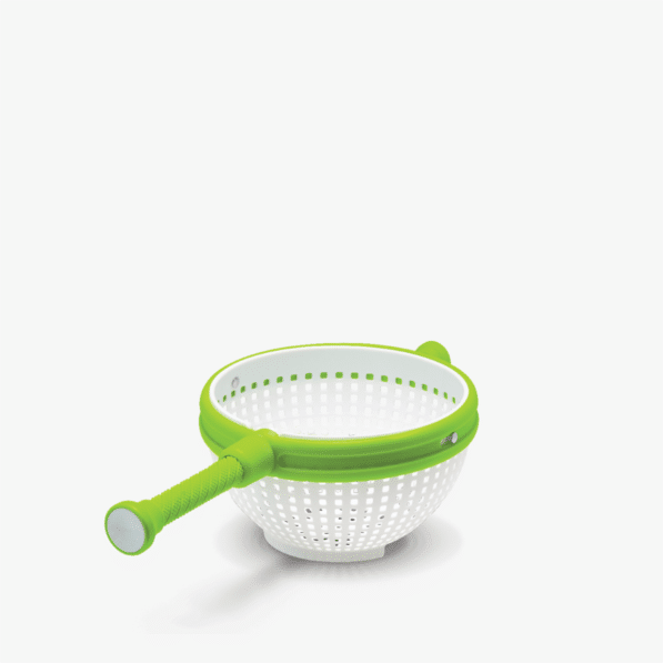 Dreamfarm Spina, a white perforated colander with a lime green spinning handle