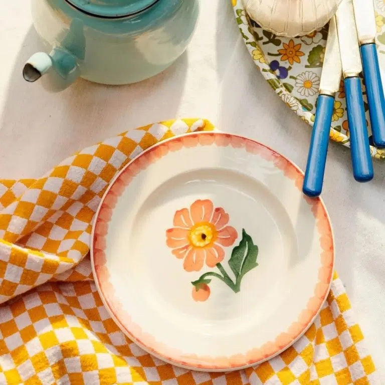Emma Bridgewater Dahlia 6 1/2 inch plate with a peach dahlia in the centre, styled on a yellow gingham cloth