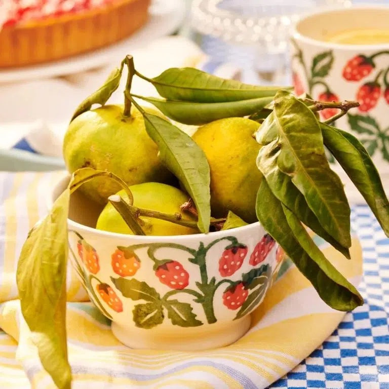 Emma Bridgewater small old bowl with a red berry and green leaf design, styled on a table and holding lemons