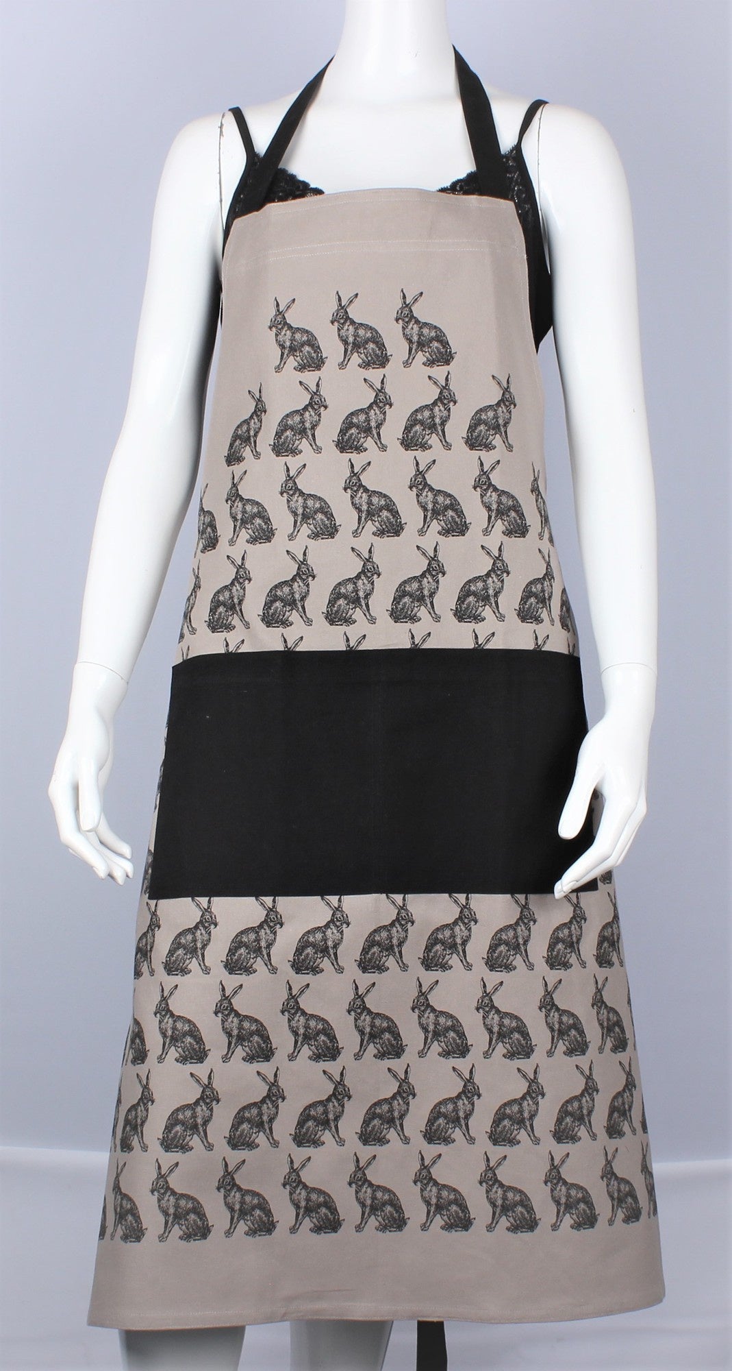 HotHouse hare apron in beige with a black print of hares and a black pocket, shown on a mannequin