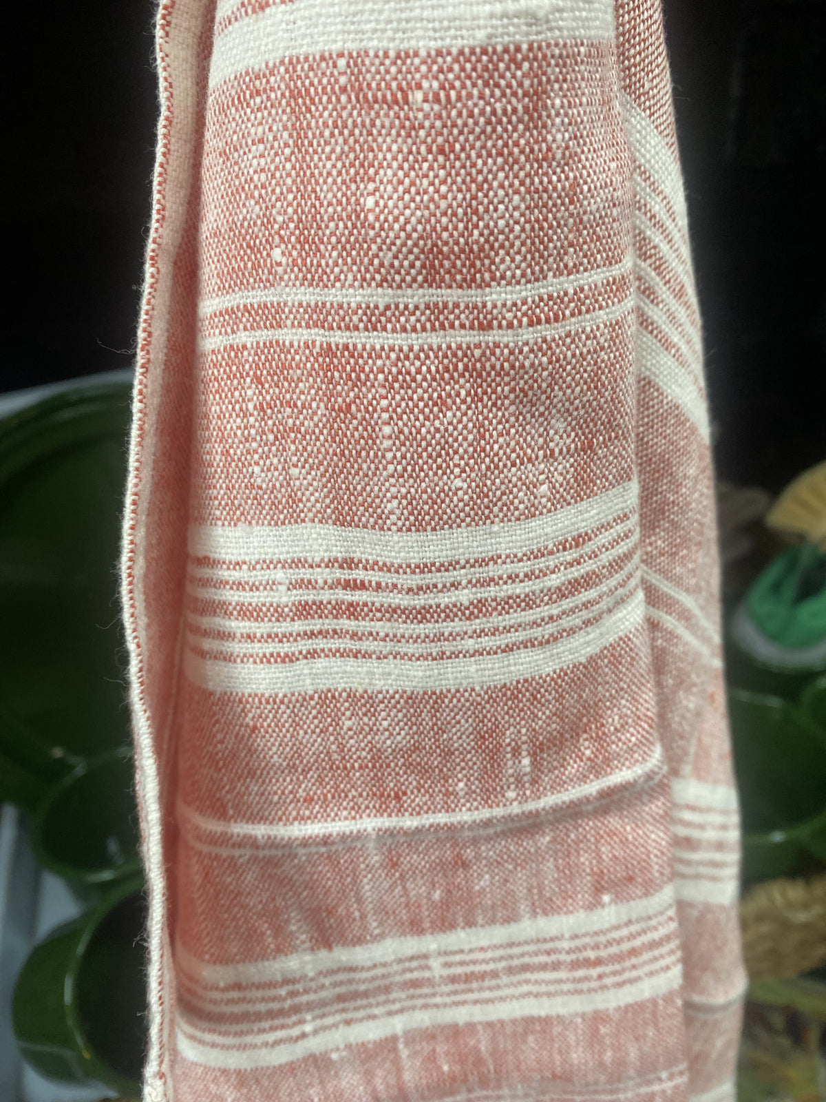 Ottoman Collection linen tea towel in red and white multistripe, hanging from a rail