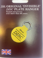 The Original Invisible Disc plate hanger, a 30mm yellow adhesive disc with a ring, on its card