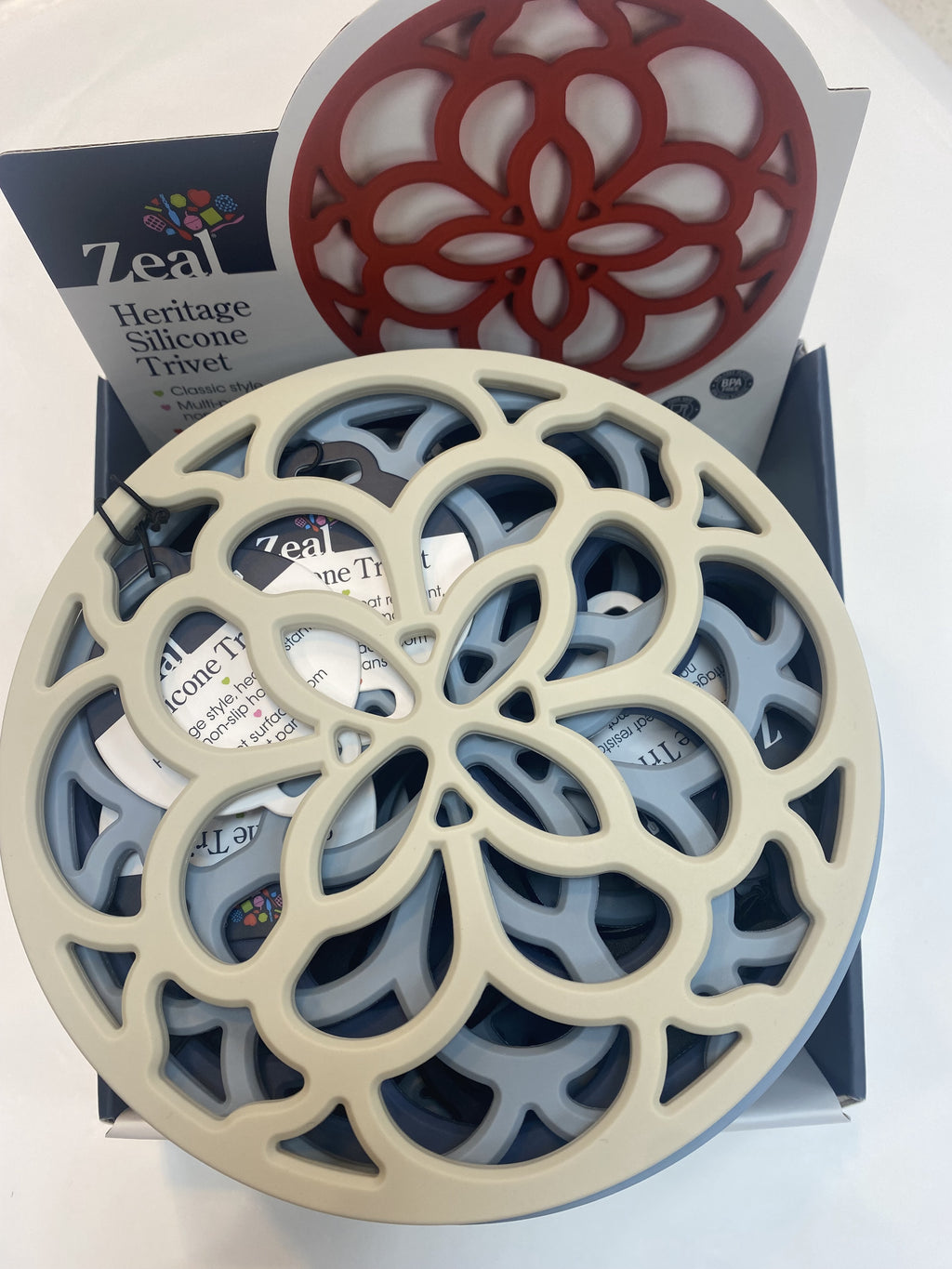 Zeal circular silicone trivets in a floral cut-out design, shown in their retail box