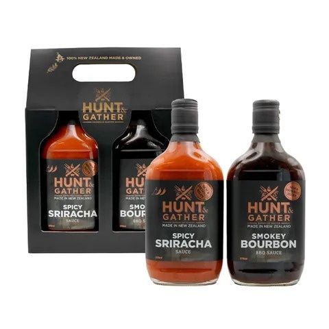 Hunt & Gather duo sauce pack with Spicy Sriracha and Smokey Bourbon bottles beside their black gift box
