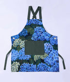 MM Linen Matilda apron with a blue hydrangea print and dark green straps