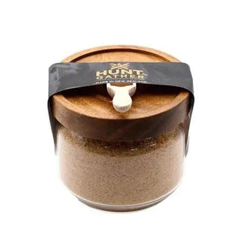 Hunt & Gather Sriracha speciality salt in a glass jar with a wooden lid and a spoon, tied with a black band