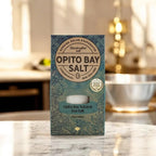 Opito Bay natural sea salt, 50g, shown in its packaging on a kitchen counter