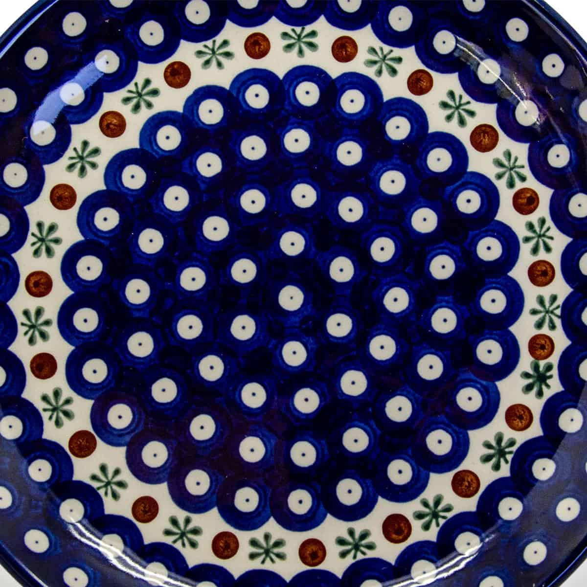 Polish Ceramics apple baker, 26x23cm, close-up of a cobalt blue dish with white dots and green and rust motifs