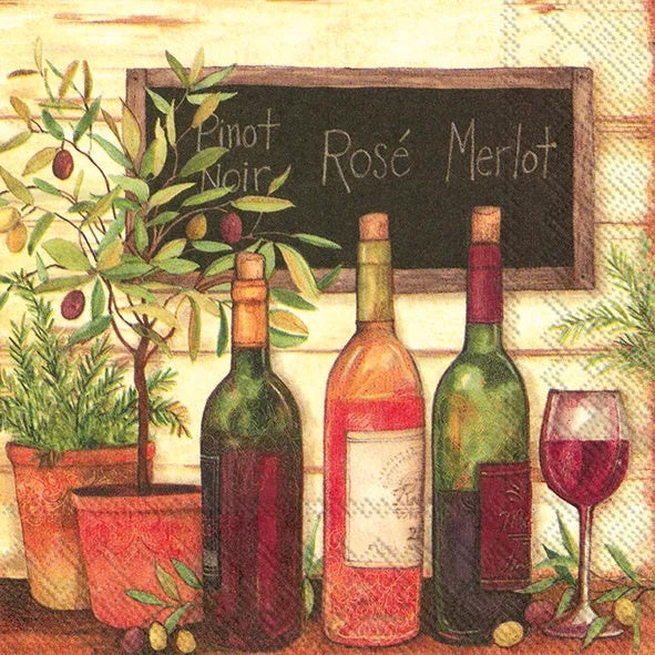IHR luncheon napkin with a painted scene of wine bottles, a glass and an olive tree
