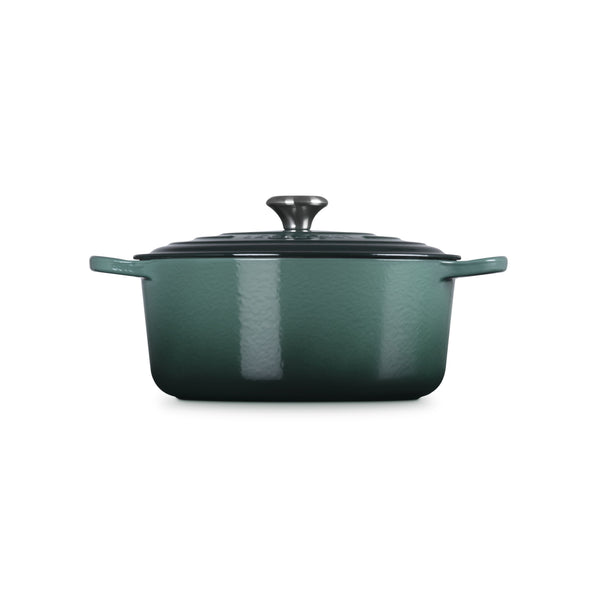 Le Creuset Signature casserole in deep green enamelled cast iron with a lid and two handles