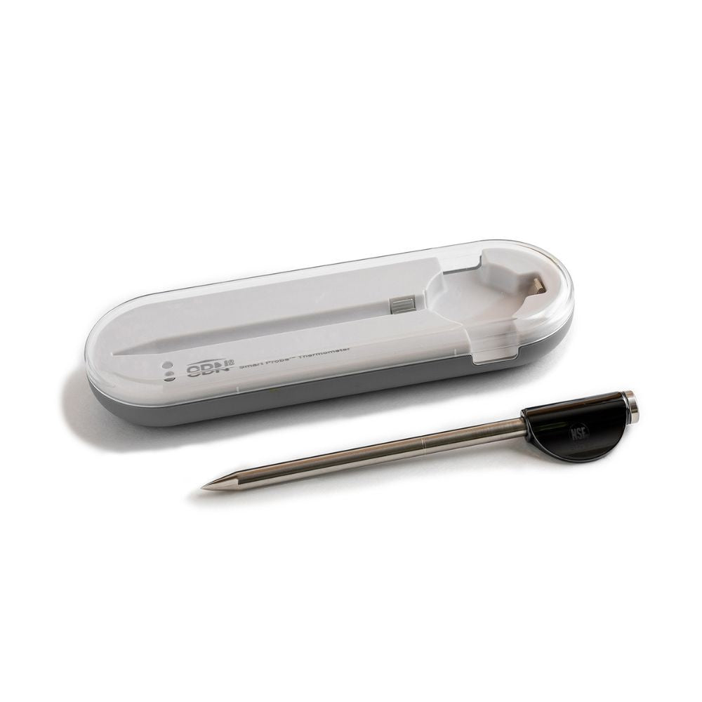 CDN Smart Probe thermometer, a slim wireless probe with a black cap, beside its charging case