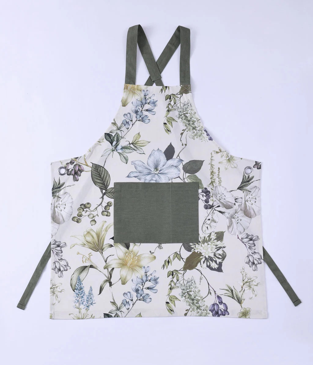 MM Linen Sanctuary apron in white with a botanical flower print and a green pocket and straps