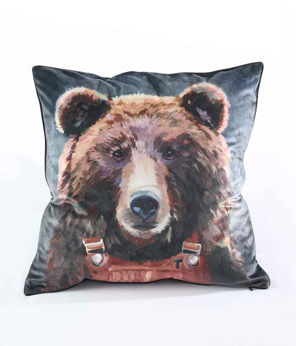 MM Linen Threadbear cushion with a painted brown bear wearing dungarees on a dark velvet cover