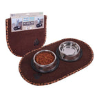 Brown pet bowl mat with two metal bowls containing food and water, with packaging in the background.